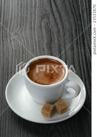 cup of freshly made espresso on wood board 23531670