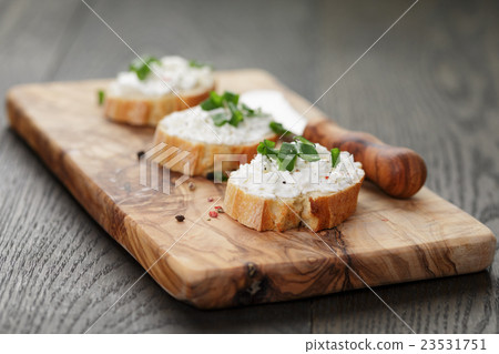 crunchy baguette slices with cream cheese and crunchy baguette slices with cream cheese and 23531751