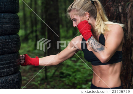 Portrait of girl boxer doing uppercut kick working 23536739
