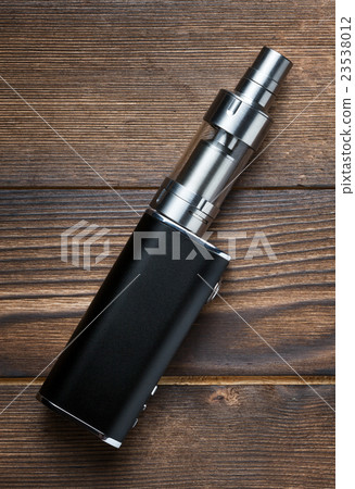 electronic cigarette on brown wooden background 23538012
