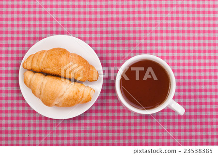 Cup of tea and two buns on the tablecloth. Cup of tea and two buns on the tablecloth. 23538385