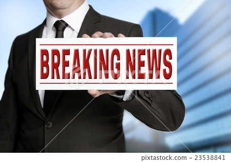 breaking news sign is held by businessman breaking news sign is held by businessman 23538841