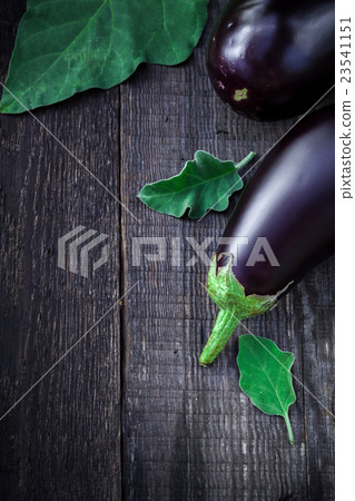 Fresh aubergine on vintage wood background Fresh aubergine on vintage wood background 23541151