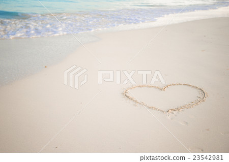Heart drawn in the sand. Beach background. Top 23542981