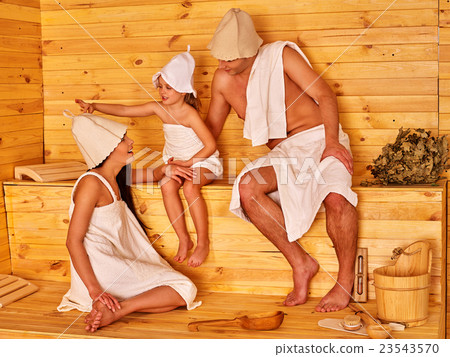 Happy people with child in hat at sauna. Happy people with child in hat at sauna. 23543570