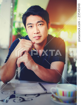 Happy young Asian business man thinking Happy young Asian business man thinking 23546548