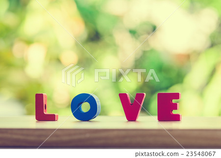 Love alphabet t on wooden table over light bokeh 23548067