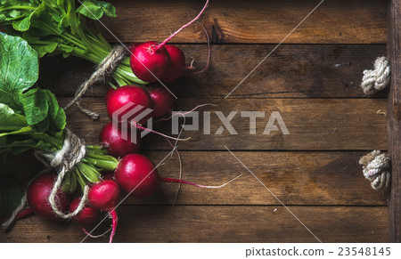 Fresh radish banches on wooden tray background Fresh radish banches on wooden tray background 23548145