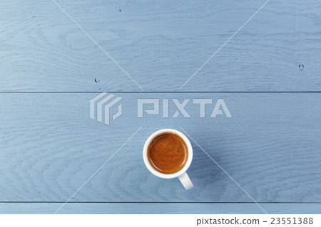 cup of fresh espresso on vintage blue table from above cup of fresh espresso on vintage blue table from above 23551388