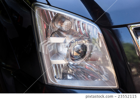 Closeup headlights of modern black car Closeup headlights of modern black car 23552115