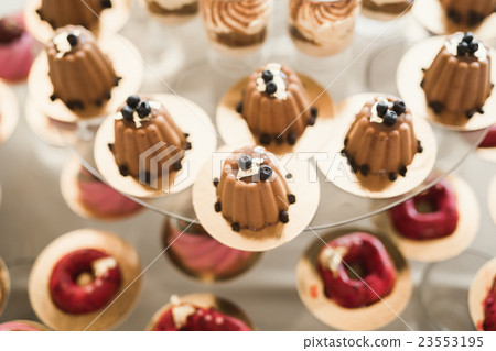 Different kinds of baked sweets on a buffet 23553195