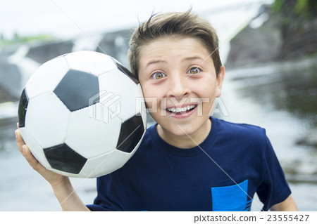 Two young boy outdoors with soccer ball smiling Two young boy outdoors with soccer ball smiling 23555427