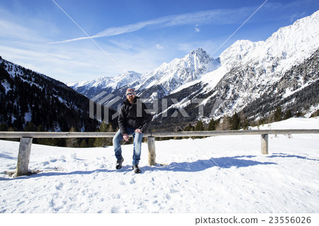 Young man enjoys winter landscape 23556026