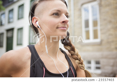 Young female runner in old city center 23557403
