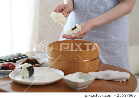 A woman holding a rice ball 23557660