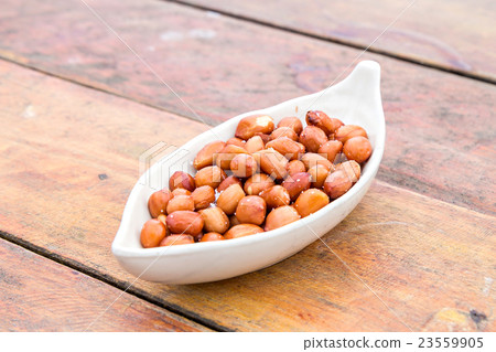 fried peel peanuts with salt on wooden table fried peel peanuts with salt on wooden table 23559905