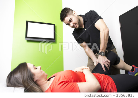 Male Osteopath Treating Female Patient With Hip Male Osteopath Treating Female Patient With Hip 23563933