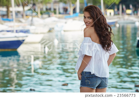 woman near the lake on a summer day woman near the lake on a summer day 23566773