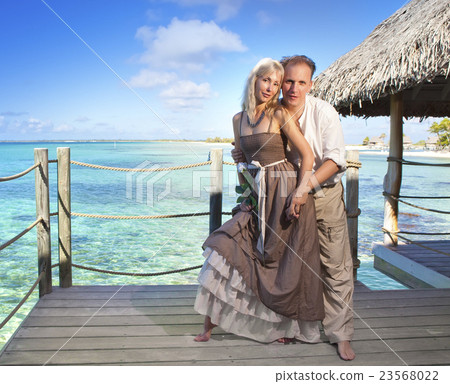 man gives a rose to the woman on the turquoise sea man gives a rose to the woman on the turquoise sea 23568022