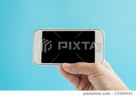 female hand holding a phone with black screen  23569381