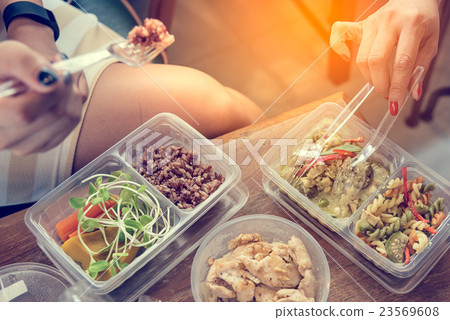 Women eating Healthy food in lunch box Women eating Healthy food in lunch box 23569608
