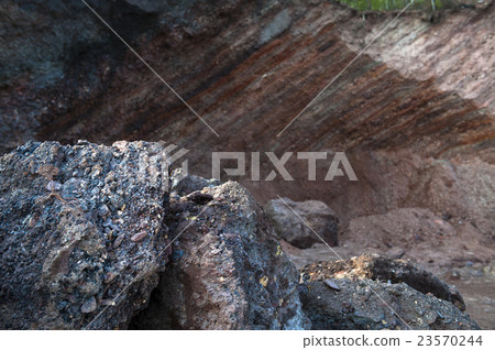 Waste heaps of red rock in industrial district 23570244