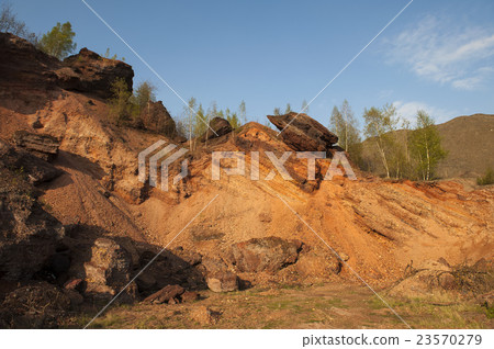 Waste heaps of red rock in industrial district Waste heaps of red rock in industrial district 23570279
