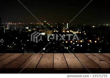 wood table top on night city background wood table top on night city background 23571735