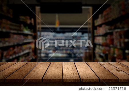 wood table top on blur supermarket background wood table top on blur supermarket background 23571736