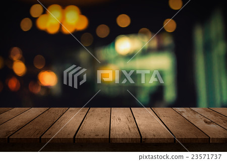 wooden table of blurred background of cafe lights 23571737