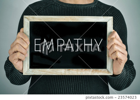 man with a chalkboard with the text empathy 23574023