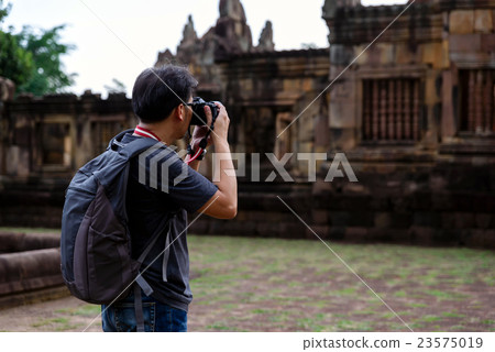 Smart man with backpack taking a photo 23575019