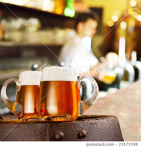 Two glasses of beer in the bar 23575599