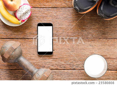 Dumbbell and smart phone with milk and fruit. Dumbbell and smart phone with milk and fruit. 23580808