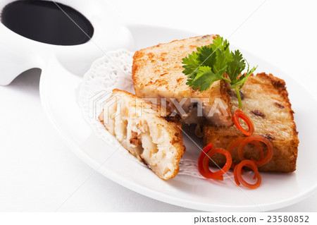 Fried Radish cake on plate with black sauce 23580852