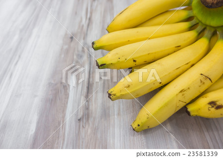 Fresh bananas on wooden table . Fresh bananas on wooden table . 23581339