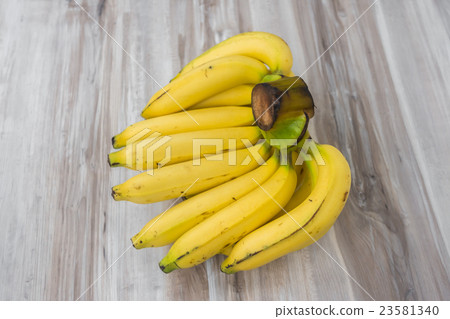 Fresh bananas on wooden table . Fresh bananas on wooden table . 23581340