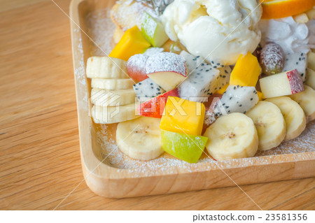 Pancake and fruit with ice cream on table . 23581356