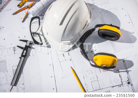 Construction plans with White helmet and drawing tools on blueprints . Construction plans with White helmet and drawing tools on blueprints . 23581500