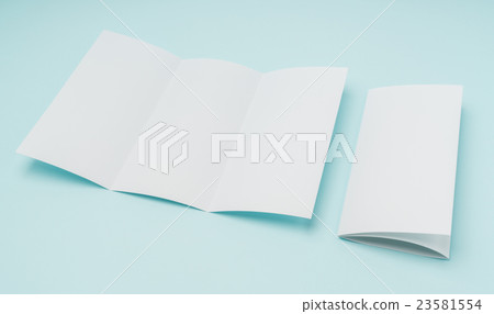 Trifold white template paper on blue background . Trifold white template paper on blue background . 23581554