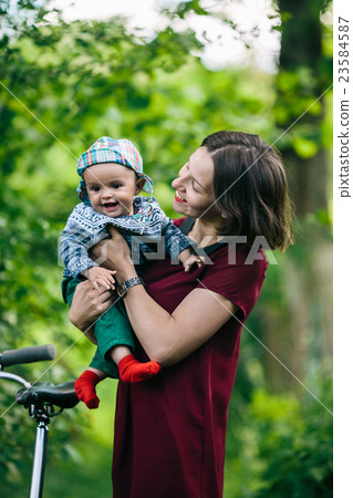 young family with a child on the nature 23584587