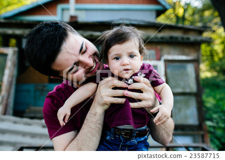 young family with a child on the nature 23587715