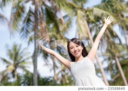 young woman raising her arms 23589640