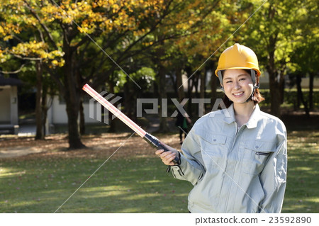 A woman in a work clothes in a park 23592890