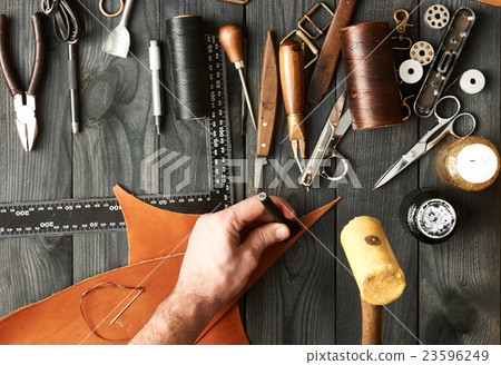 Man working with leather Man working with leather 23596249