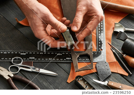 Man working with leather Man working with leather 23596250