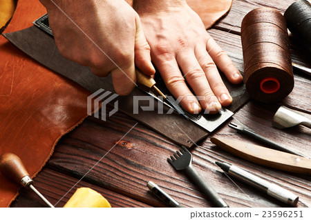 Man working with leather Man working with leather 23596251