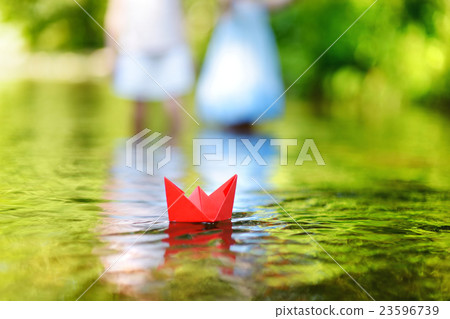 A paper boat floating on a river 23596739
