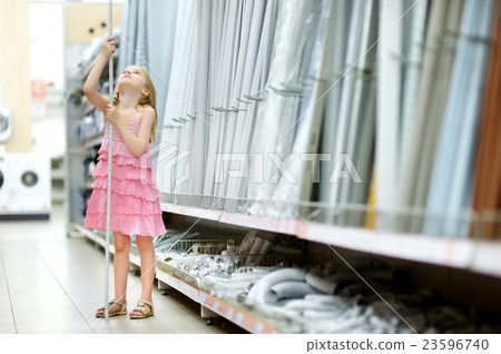 Adorable girl in a houseware store 23596740