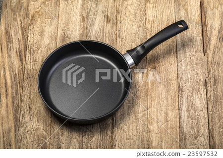 Frying pan on wooden Frying pan on wooden 23597532